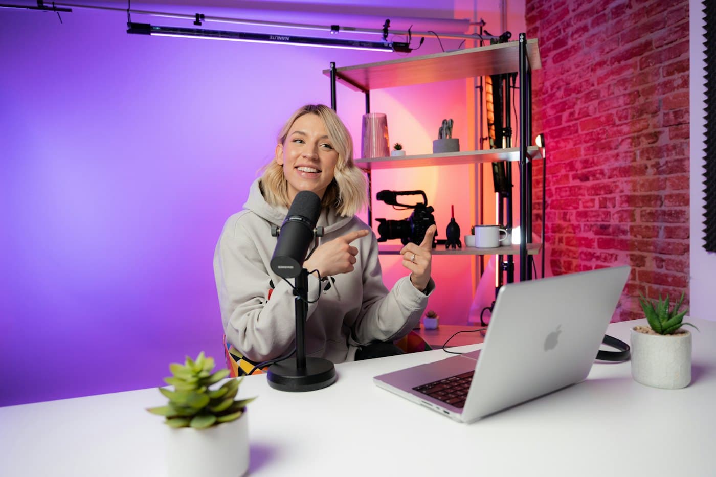 A woman sitting in front of a laptop editing content